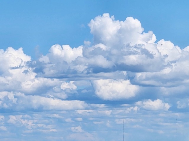 clouds float in a blue sky
